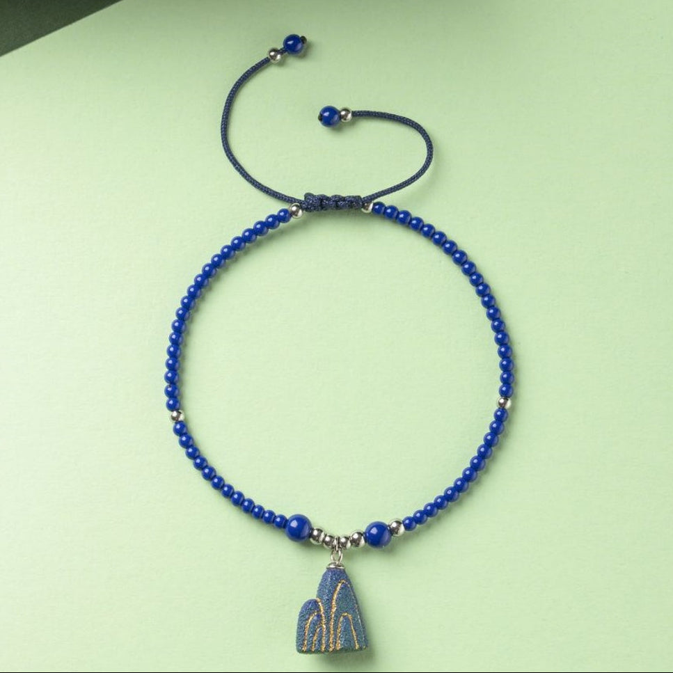 Artisanal Mountain-Themed Teal Ceramic Jewelry Set with Golden Patterns